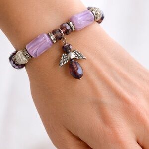 Handmade beaded bracelet featuring an angel charm. Lavender/Purple